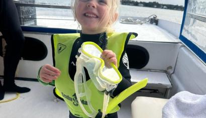 Little girl in scuba gear on a boat with Crystal River Watersports