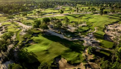 An aerial view of Cabot Citrus Farm's golf courses with dramatic lighting and shadows at sunset.